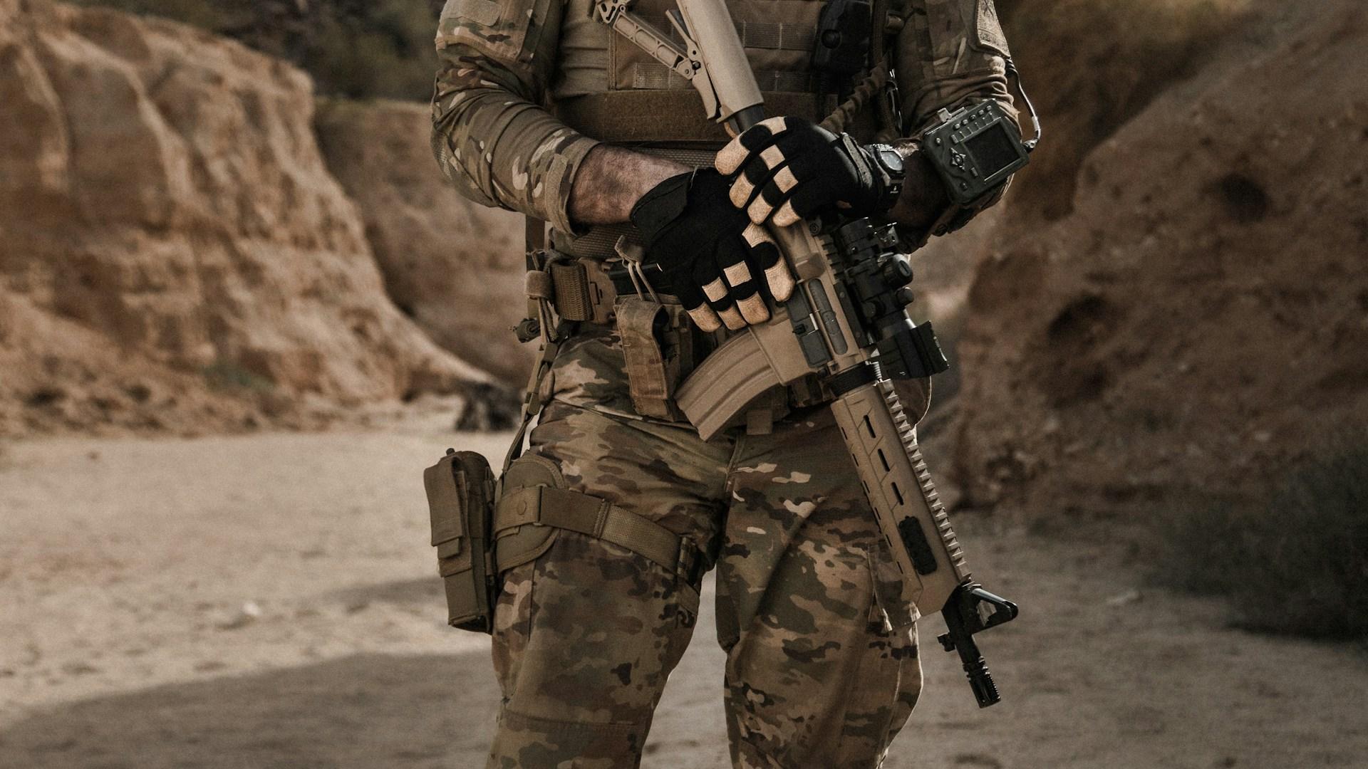 Military personnel with weapon